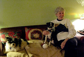 Photo of Dr. Nancy Whitt on sofa with dogs